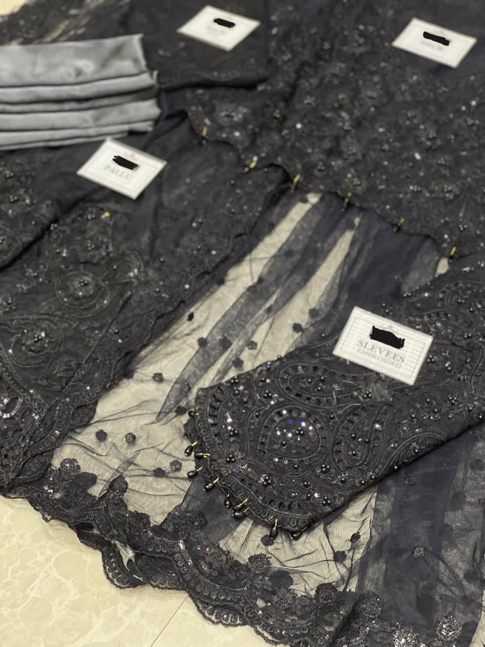 Maria B Black Net Saree with heavy embroidery, adda work, cutwork borders, tassel pallu, and silk petticoat – 2025 Exclusive.