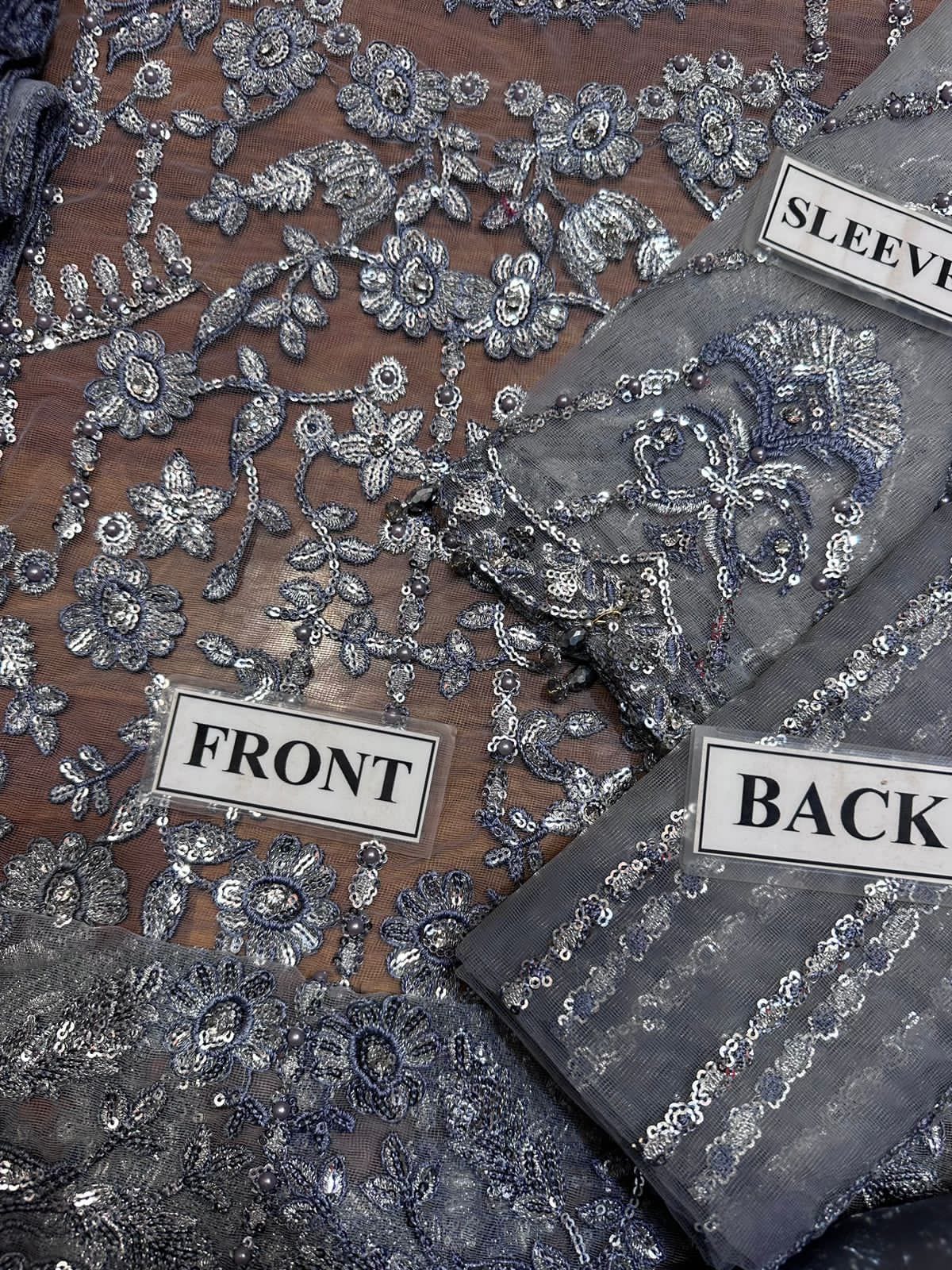 LAAM embroidered net suit with satin silk, sequence work, fancy tussles, embroidered dupatta & plain trouser.
